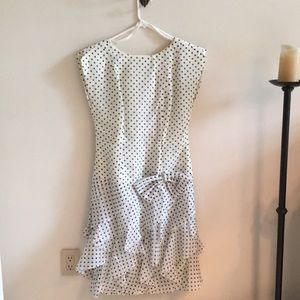 White w black polkadots dress and bow in front